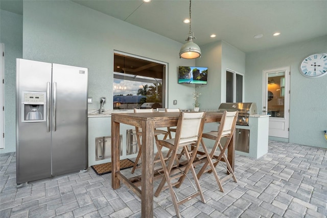 kitchen with hanging light fixtures and stainless steel fridge