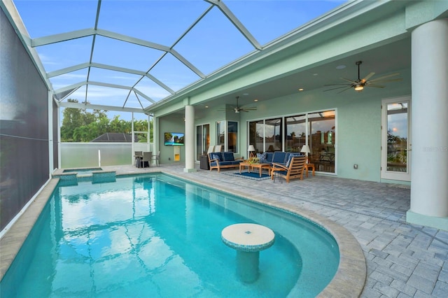 view of pool featuring a patio area, outdoor lounge area, ceiling fan, and glass enclosure