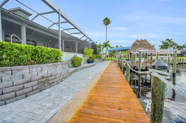 view of dock featuring a water view and glass enclosure