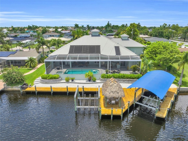 exterior space with a lanai and a water view