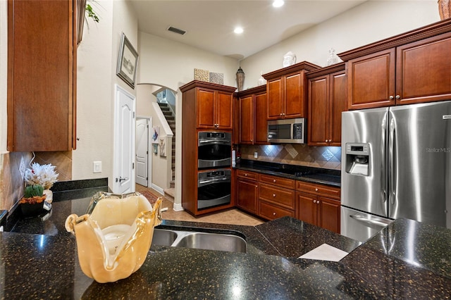 kitchen with sink, appliances with stainless steel finishes, and backsplash