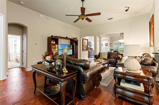 living room featuring dark wood-type flooring and ceiling fan