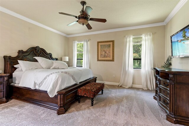 carpeted bedroom with multiple windows, ceiling fan, and crown molding