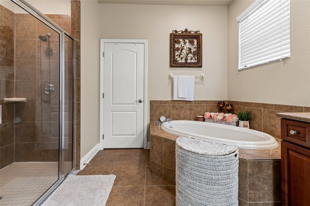 bathroom with independent shower and bath, vanity, and tile patterned floors