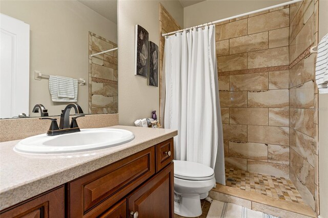 bathroom with vanity, a shower with curtain, toilet, and tile patterned flooring