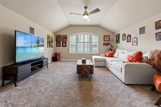 living room featuring a textured ceiling, light colored carpet, vaulted ceiling, and ceiling fan