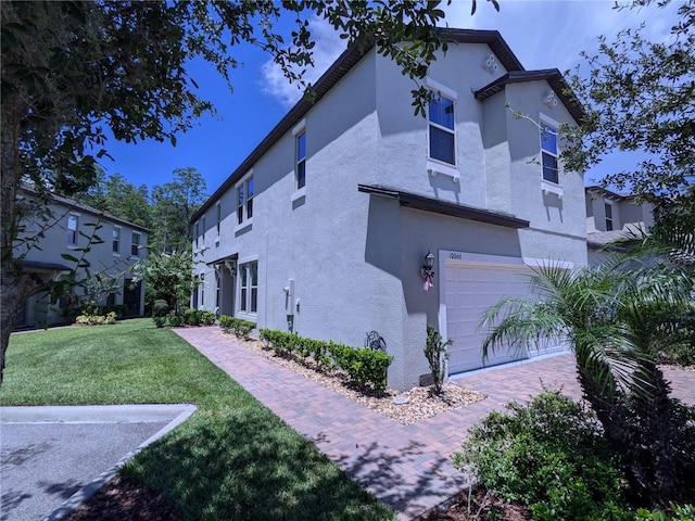 view of home's exterior with a garage and a lawn