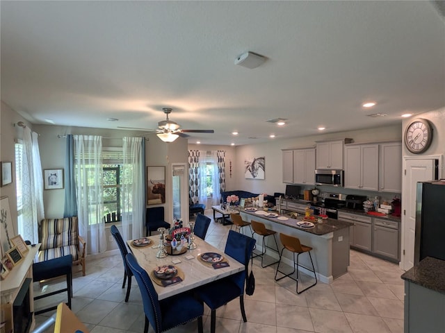 tiled dining room featuring ceiling fan