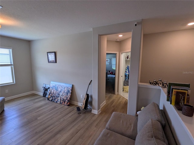 living room featuring light hardwood / wood-style flooring and a textured ceiling