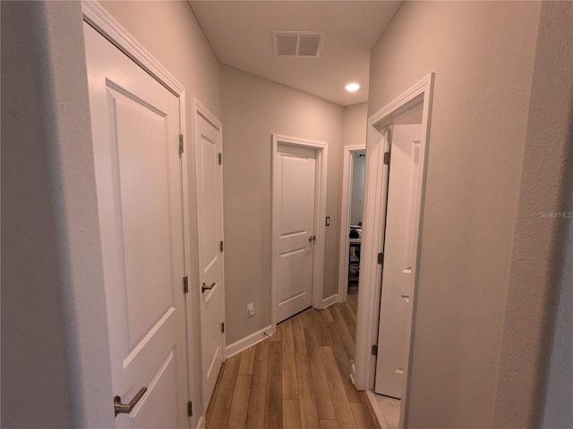 hallway with light hardwood / wood-style flooring