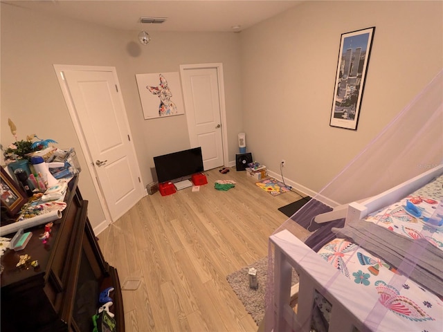 bedroom with light hardwood / wood-style flooring