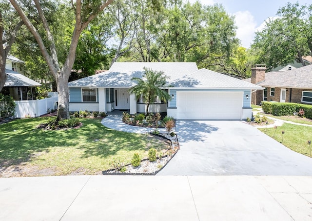 ranch-style home featuring a garage and a front lawn