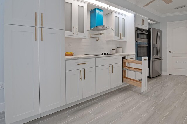 kitchen featuring white cabinetry, ceiling fan, crown molding, appliances with stainless steel finishes, and backsplash