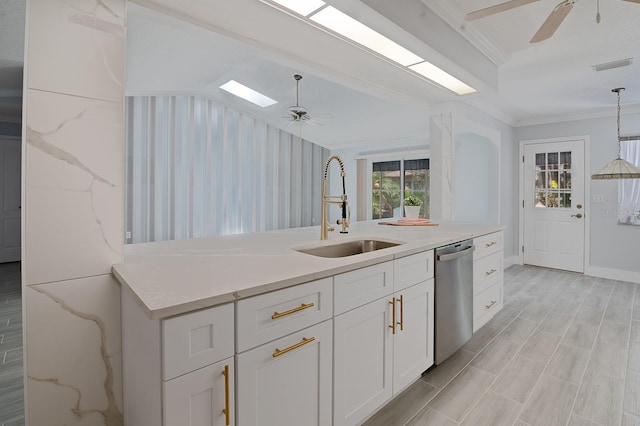 kitchen with white cabinets, sink, crown molding, dishwasher, and ceiling fan