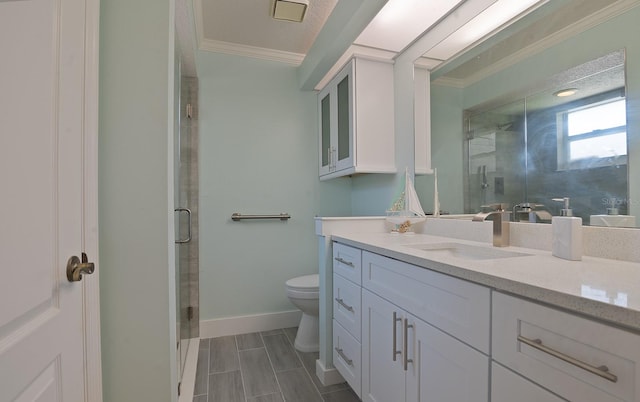 bathroom featuring vanity, tile patterned floors, crown molding, toilet, and a shower with door