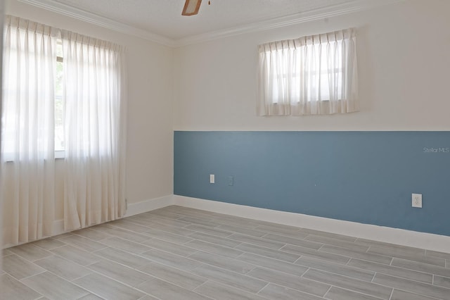 unfurnished room with a textured ceiling, crown molding, and plenty of natural light