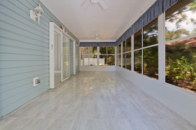 unfurnished sunroom with ceiling fan