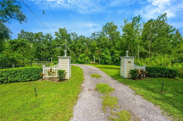 view of gate featuring a lawn