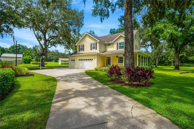 view of front of property featuring a garage and a front yard