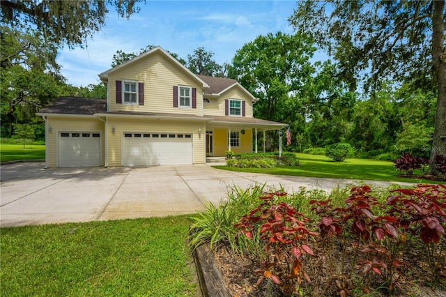 view of front of property featuring a garage, a front yard, and covered porch