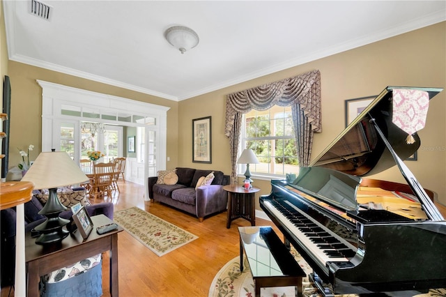 sitting room featuring hardwood / wood-style flooring and ornamental molding