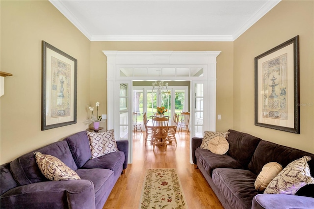 living room featuring ornamental molding and light hardwood / wood-style flooring