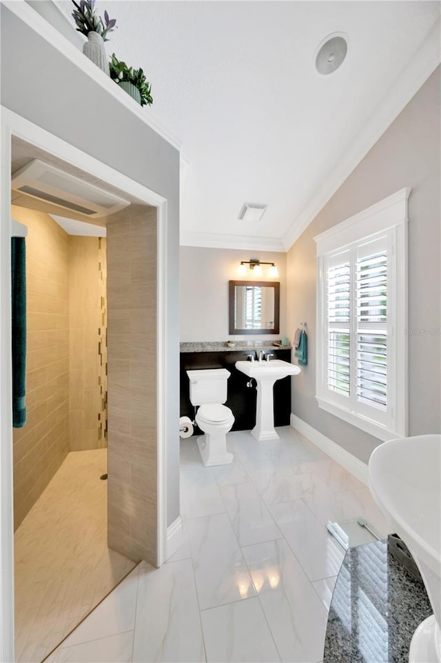 bathroom featuring ornamental molding and toilet