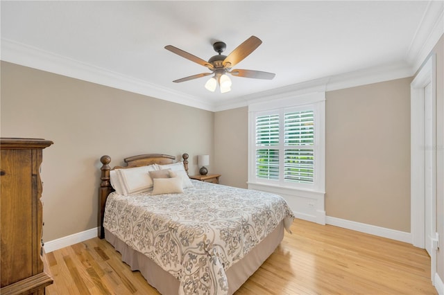 bedroom with crown molding, light hardwood / wood-style floors, and ceiling fan