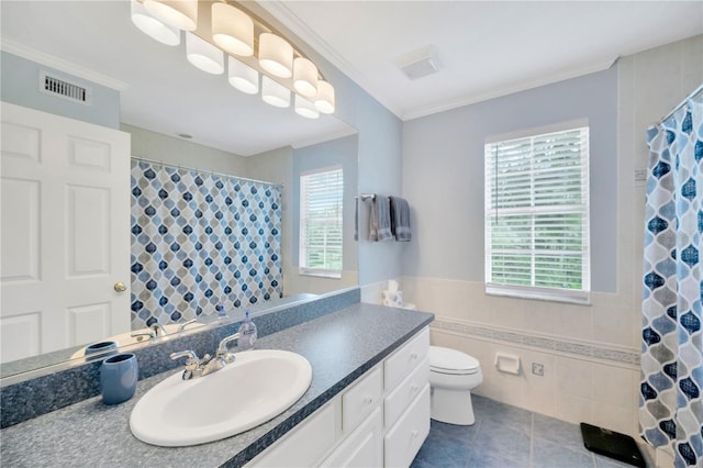 bathroom with tile patterned floors, toilet, tile walls, and a wealth of natural light