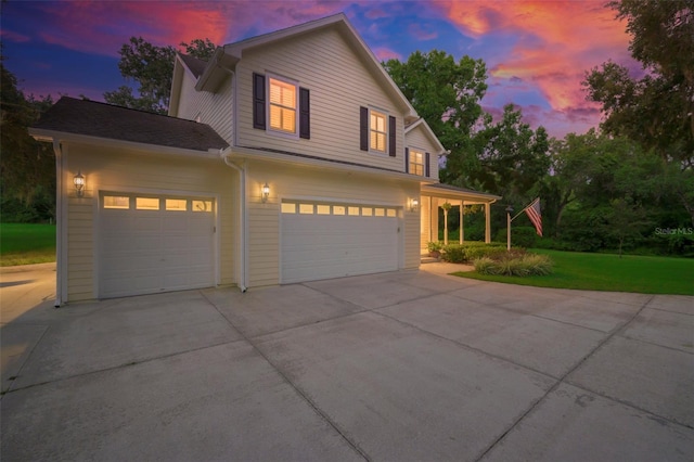 view of front facade with a garage and a yard