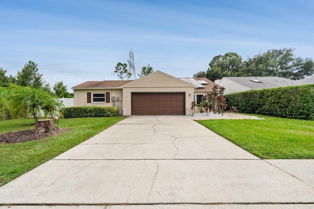 ranch-style house featuring a garage and a front lawn