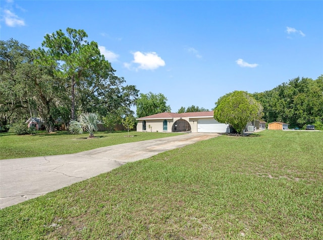 ranch-style house with a garage and a front yard