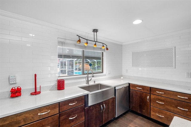 kitchen featuring sink, crown molding, dark hardwood / wood-style floors, dishwasher, and pendant lighting