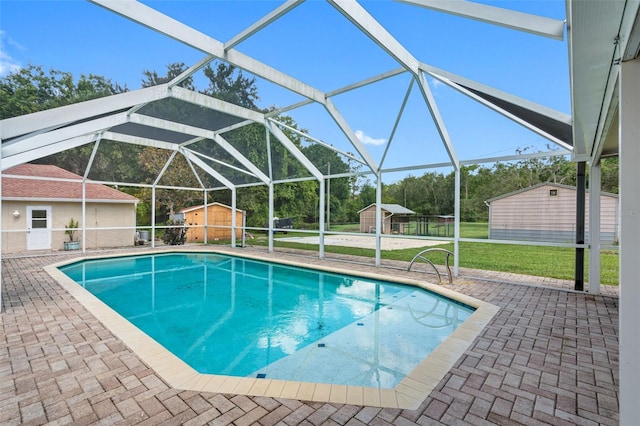 view of swimming pool with a storage shed, a lanai, a patio, and a lawn