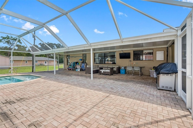 view of pool featuring a patio area and glass enclosure