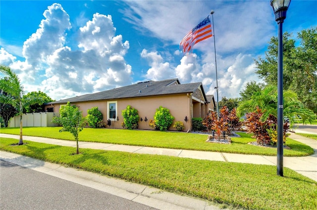 view of side of property with a yard