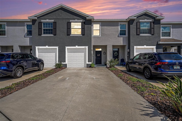 townhome / multi-family property featuring a garage