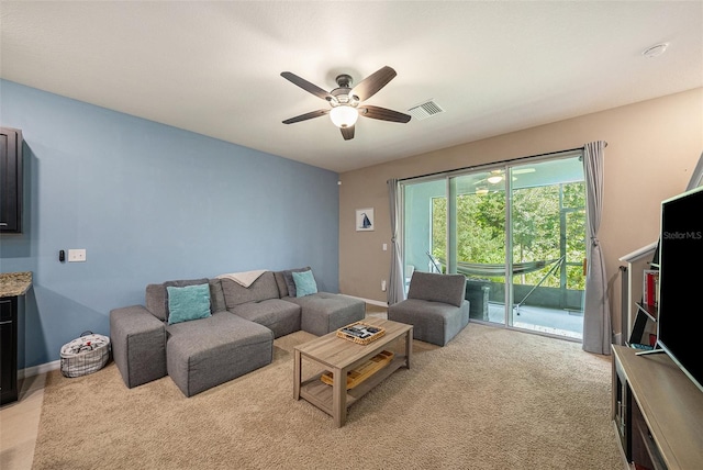 living room featuring light colored carpet and ceiling fan