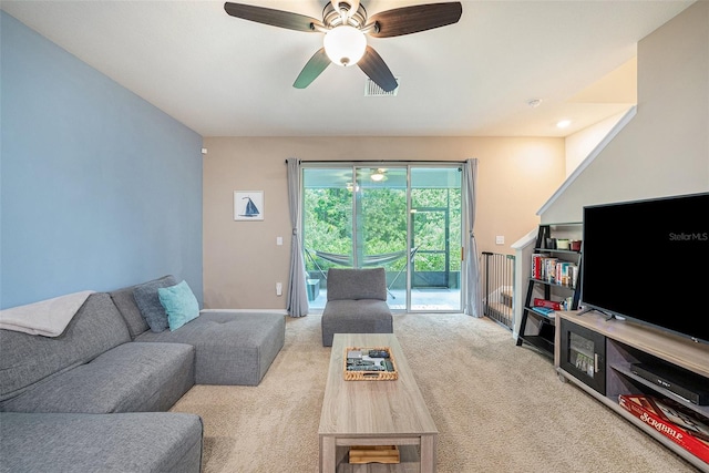 living room featuring light colored carpet and ceiling fan