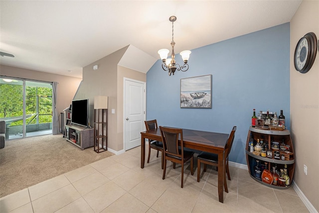 dining area featuring a chandelier and light colored carpet