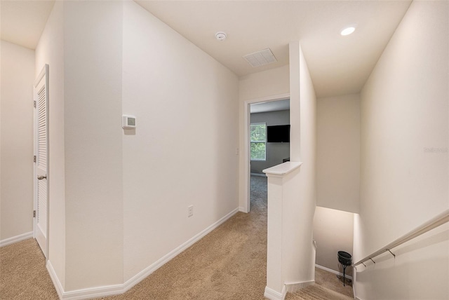 hallway featuring light carpet