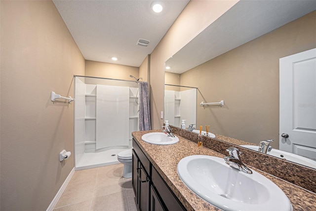 bathroom featuring vanity, toilet, tile patterned flooring, and a shower with curtain