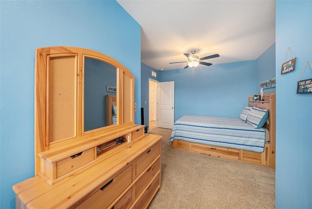 bedroom with ceiling fan and light carpet