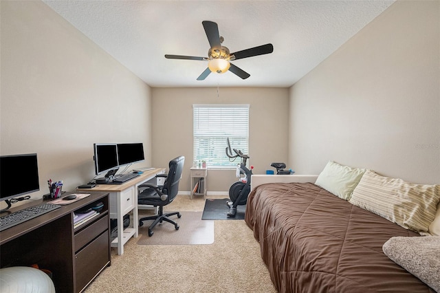 carpeted bedroom with ceiling fan and a textured ceiling