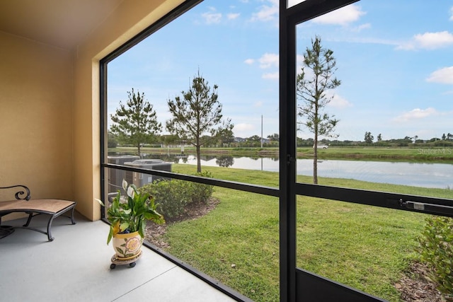 sunroom with a healthy amount of sunlight and a water view