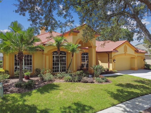 mediterranean / spanish home featuring a front yard