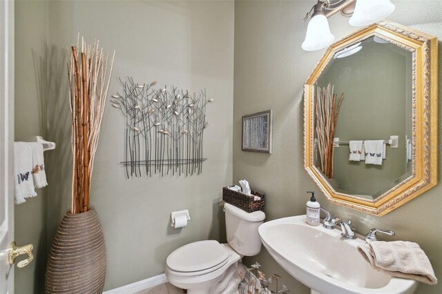 bathroom featuring sink and toilet