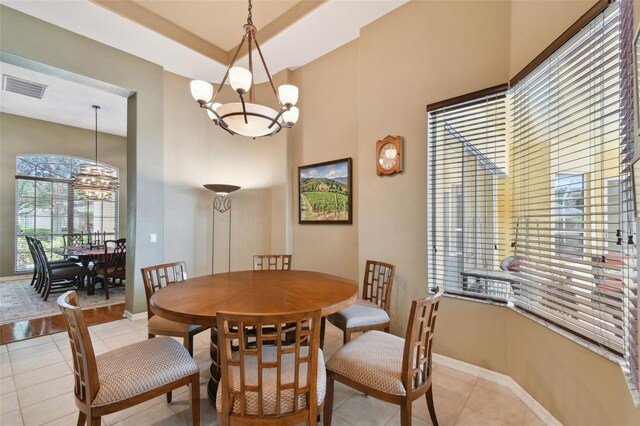 dining space with an inviting chandelier and light tile patterned floors