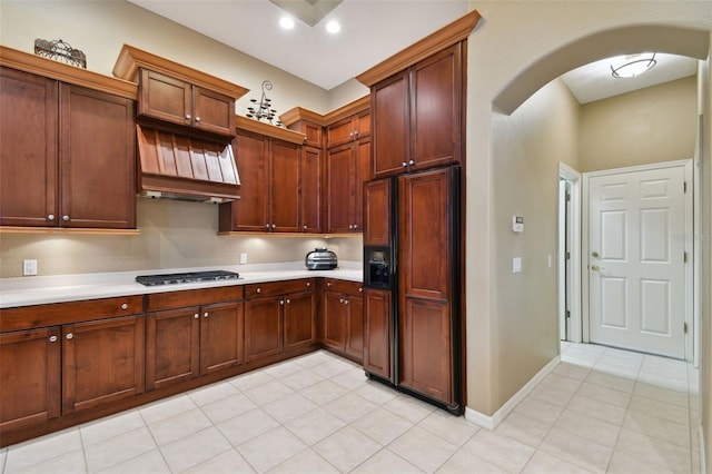 kitchen featuring light tile patterned flooring, paneled built in refrigerator, and stainless steel gas stovetop