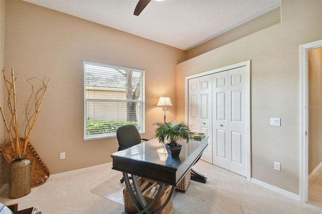 carpeted office featuring ceiling fan